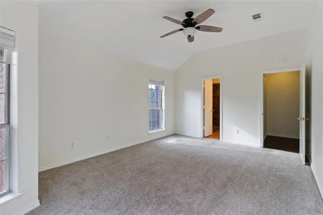 a view of empty room with ceiling fan