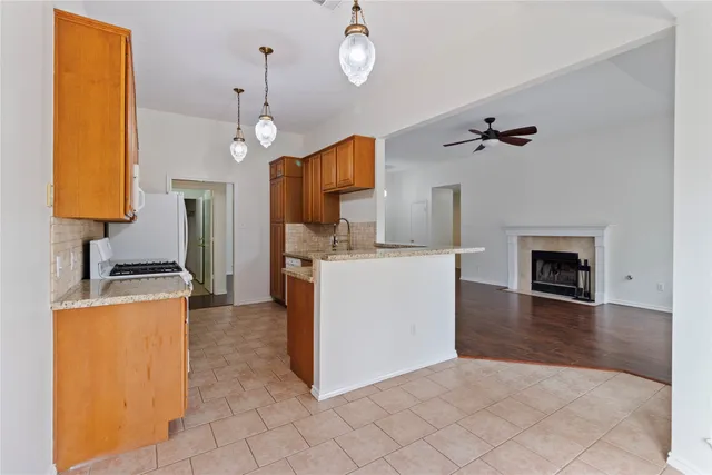 a living room with furniture a fireplace and a chandelier