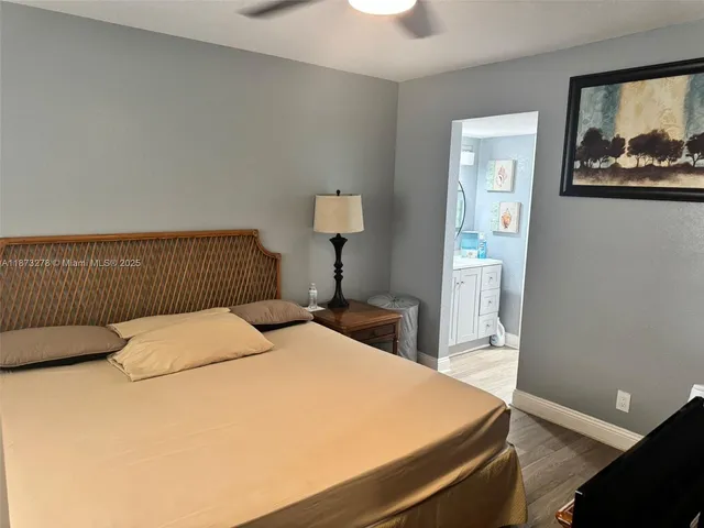 a bedroom with a bed and painting on the wall