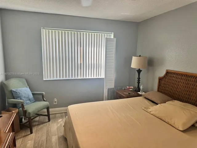 a bedroom with a bed and a chair