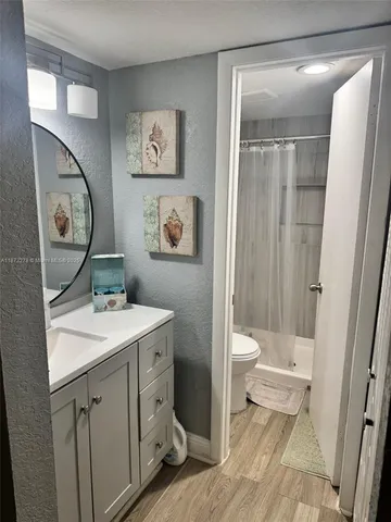 a spacious bathroom with a toilet sink and a mirror