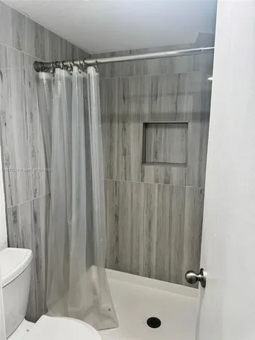 a bathroom with a shower curtain and sink