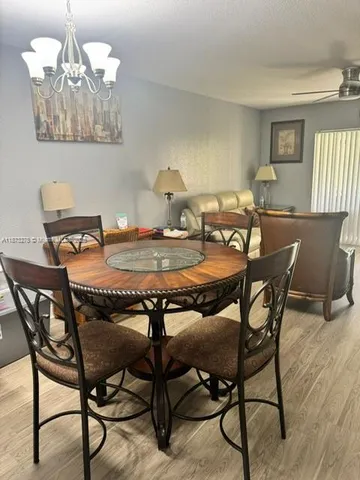 a dining room table with chairs and window