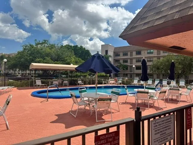 a view of a patio with swimming pool table and chairs
