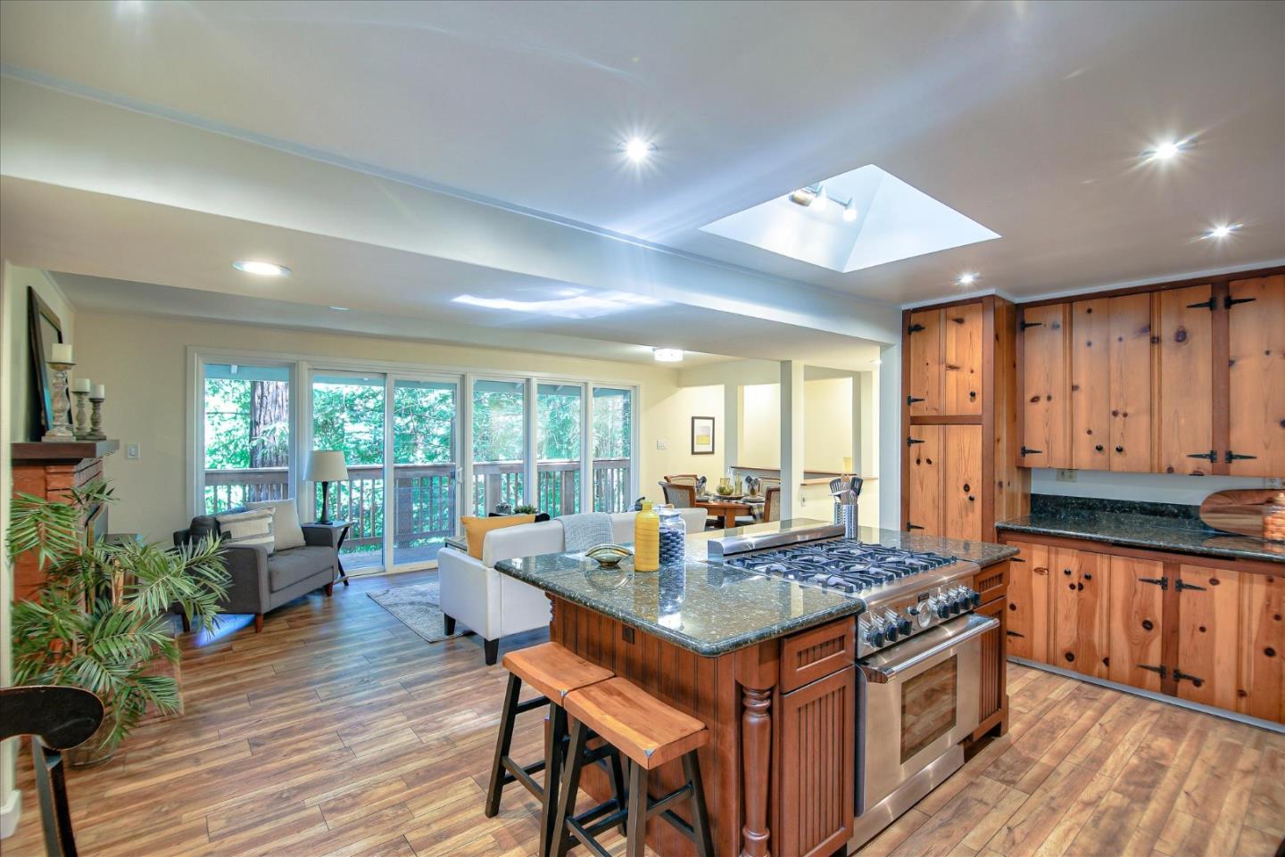 10165 Alba Road Ben Lomond, CA 95005 - Photo 4 of 44 a kitchen with granite countertop center island wooden floor and stainless steel appliances