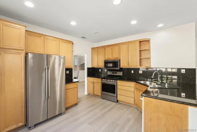 a kitchen with a table and chairs