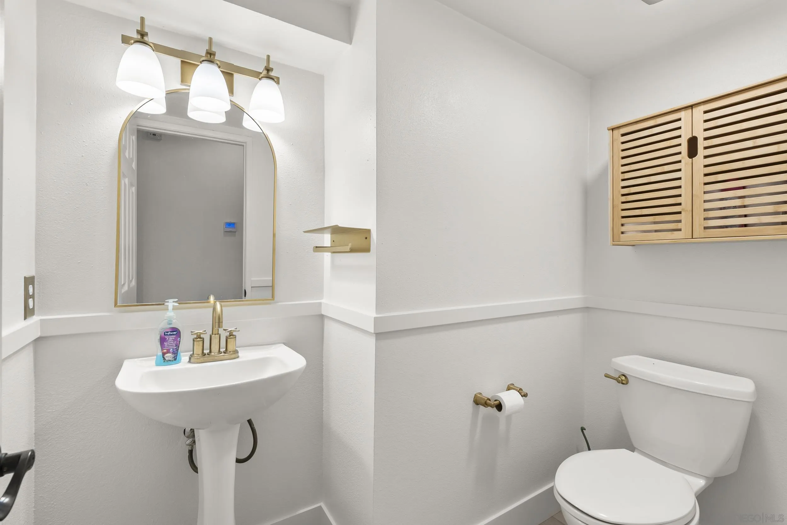 1405 Carneros Valley Street Chula Vista, CA 91913 - Photo 23 of 45 a bathroom with a sink a toilet and mirror