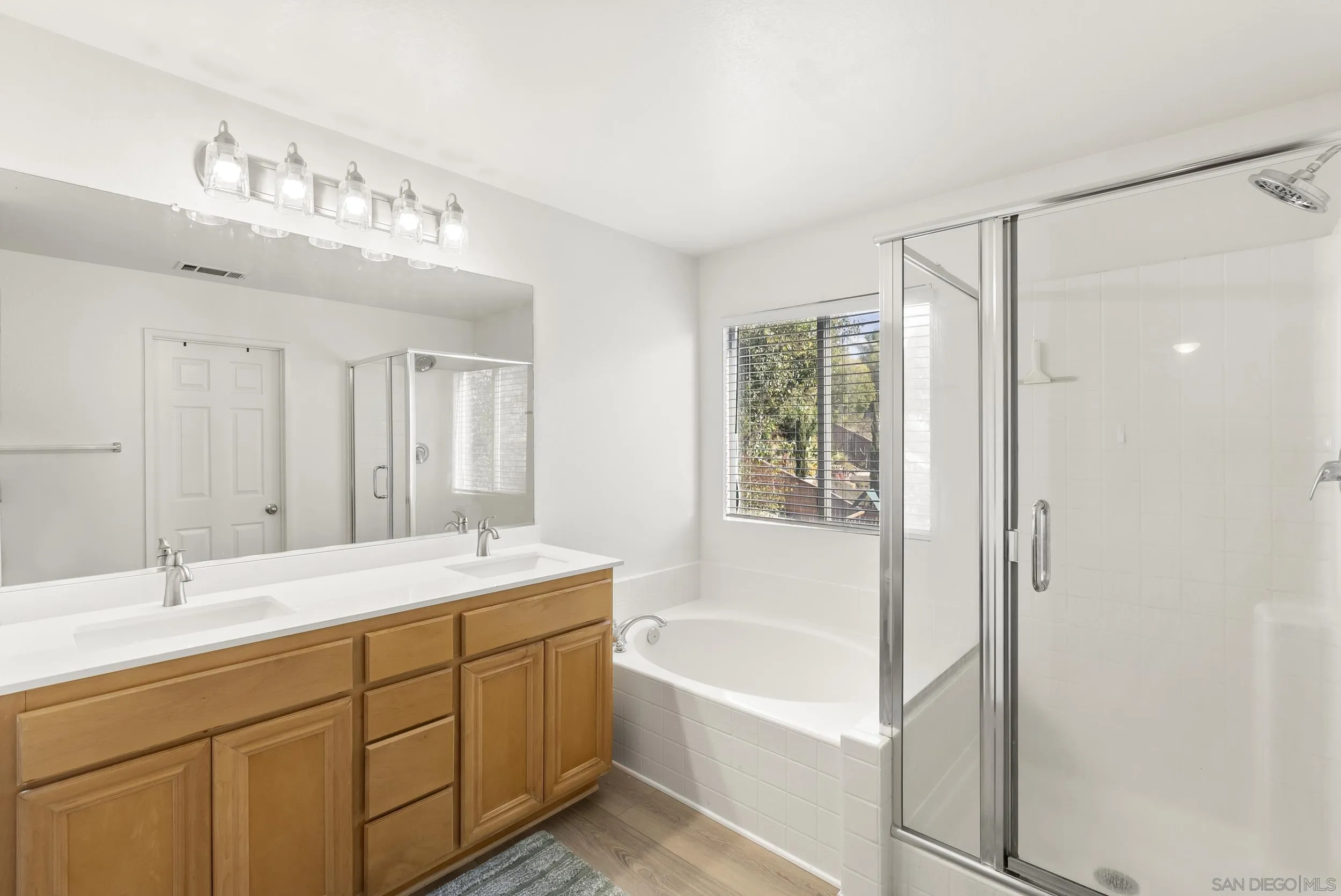 1405 Carneros Valley Street Chula Vista, CA 91913 - Photo 27 of 45 a bathroom with a tub sink and mirror