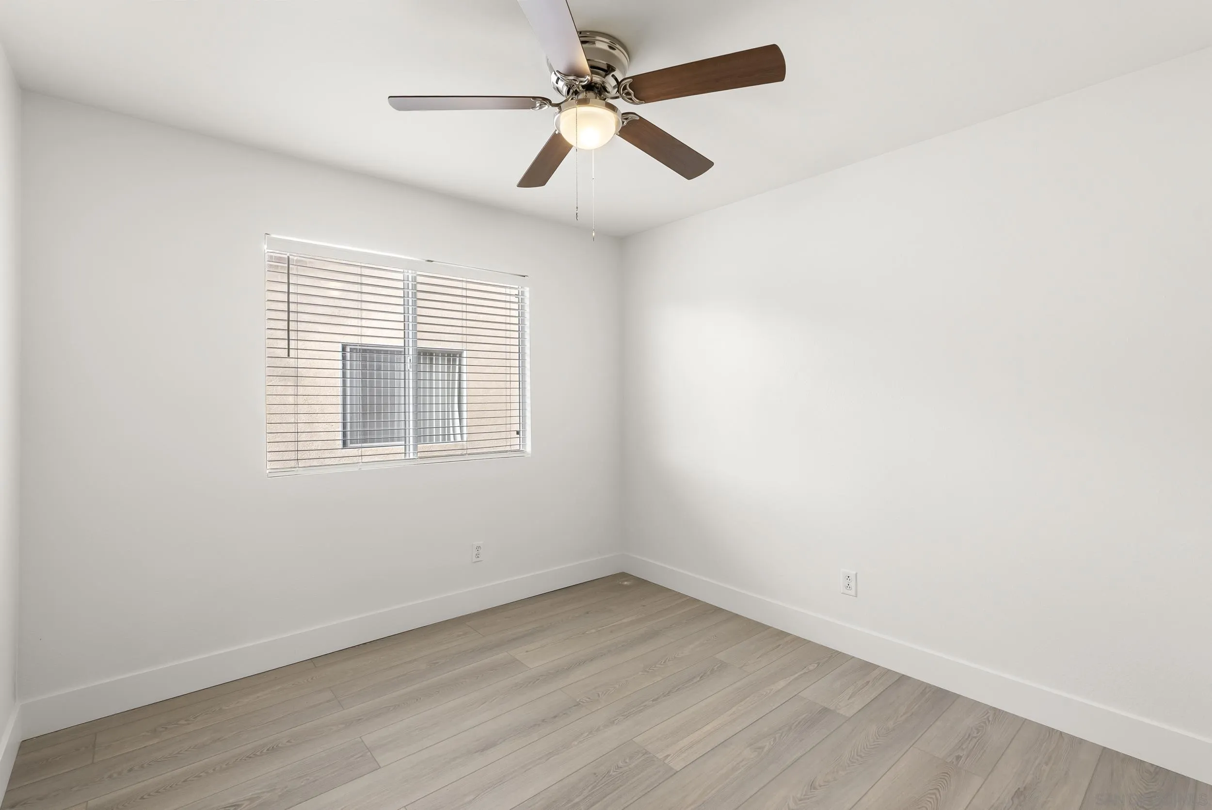 1405 Carneros Valley Street Chula Vista, CA 91913 - Photo 34 of 45 an empty room with a window and a fan