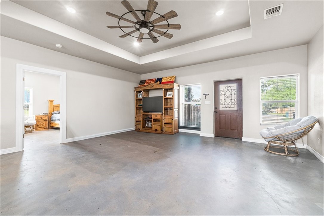 207 South Charles Street George West, TX 78022 - Photo 8 of 24 a view of a livingroom with furniture and a ceiling fan