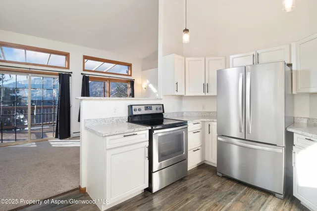a kitchen with a stove a refrigerator and a sink