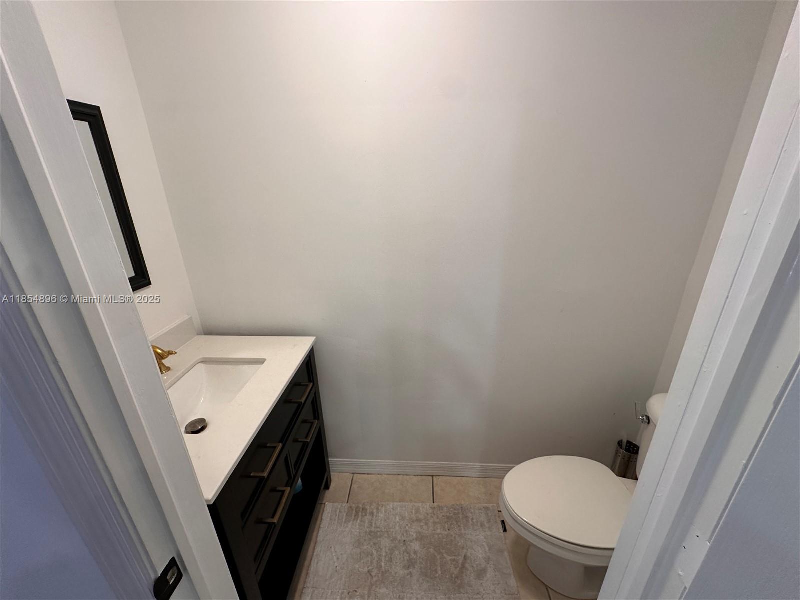 8908 Southwest 109th Avenue Miami, FL 33176 - Photo 14 of 28 a bathroom with a sink and toilet