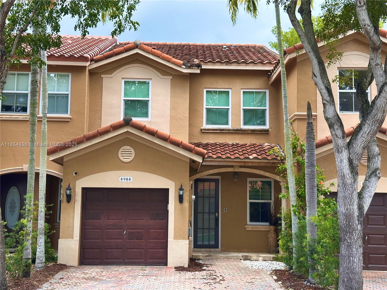 8908 Southwest 109th Avenue Miami, FL 33176 - Photo 2 of 28 a front view of a house with a garage