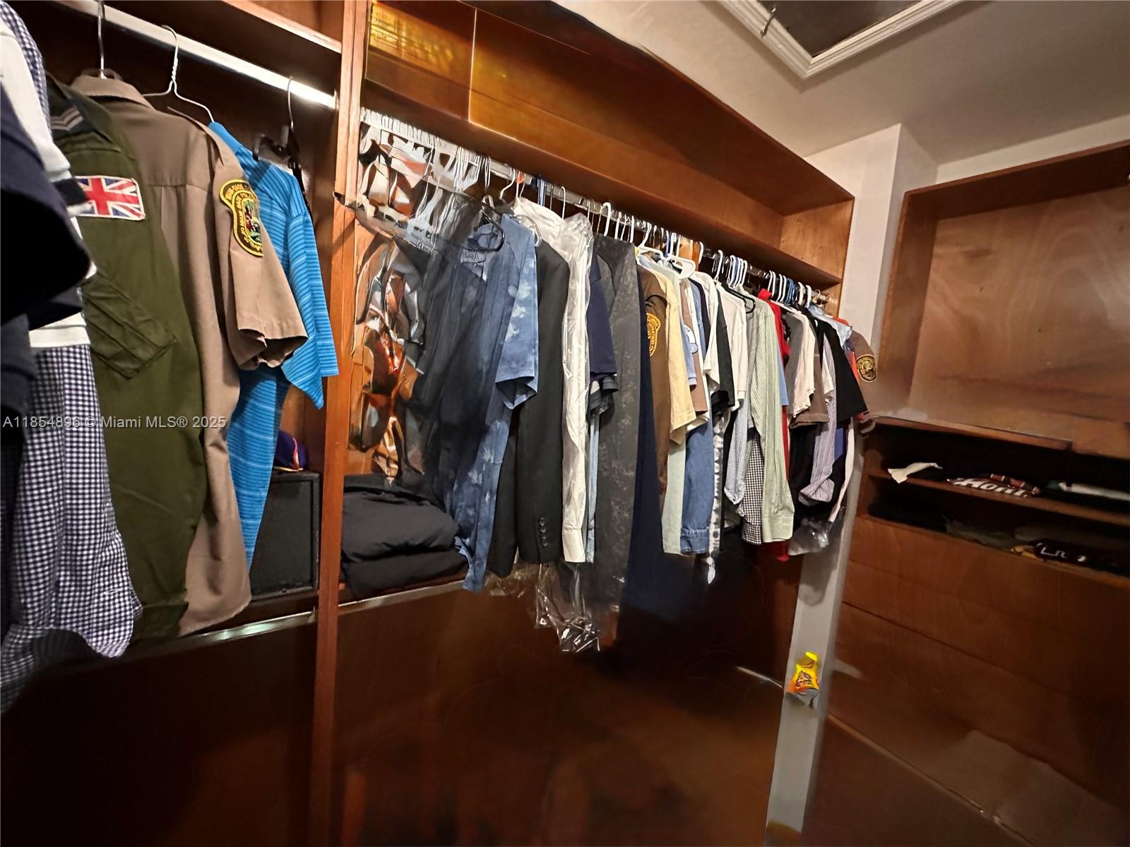 8908 Southwest 109th Avenue Miami, FL 33176 - Photo 21 of 28 a view of walk in closet with clothes and shoes