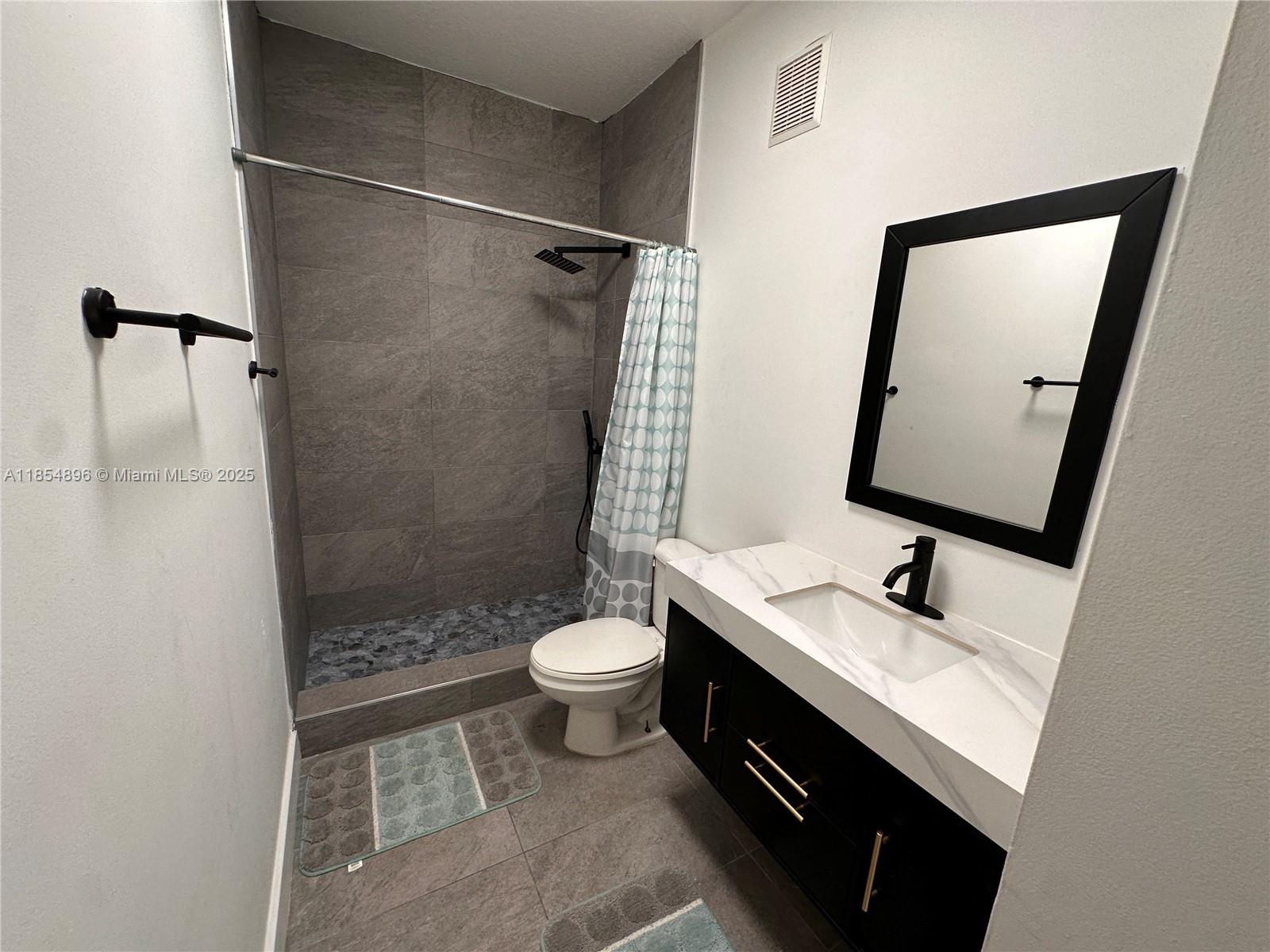 8908 Southwest 109th Avenue Miami, FL 33176 - Photo 24 of 28 a bathroom with a sink a toilet and shower