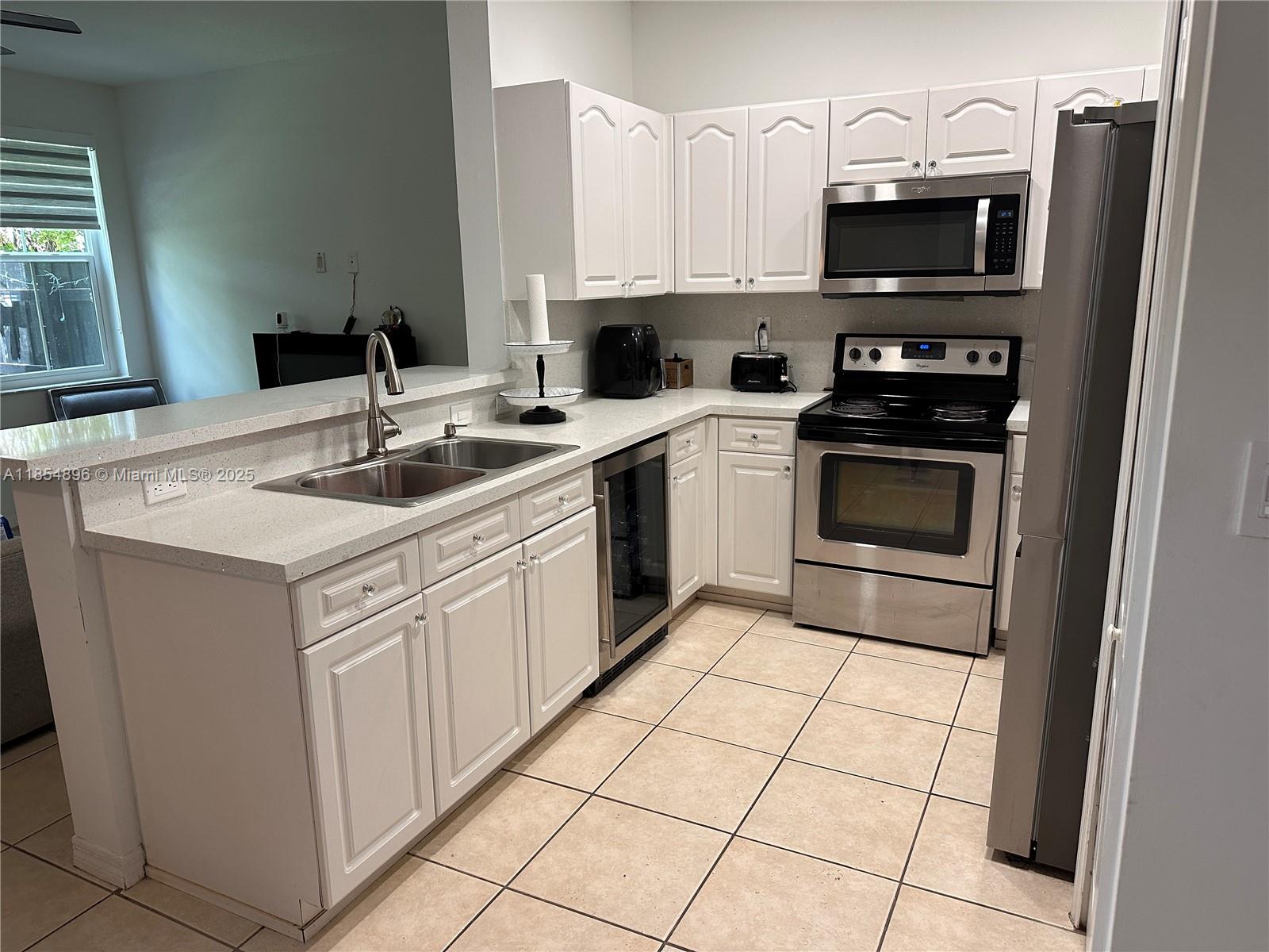 8908 Southwest 109th Avenue Miami, FL 33176 - Photo 5 of 28 a kitchen with cabinets stainless steel appliances and a sink