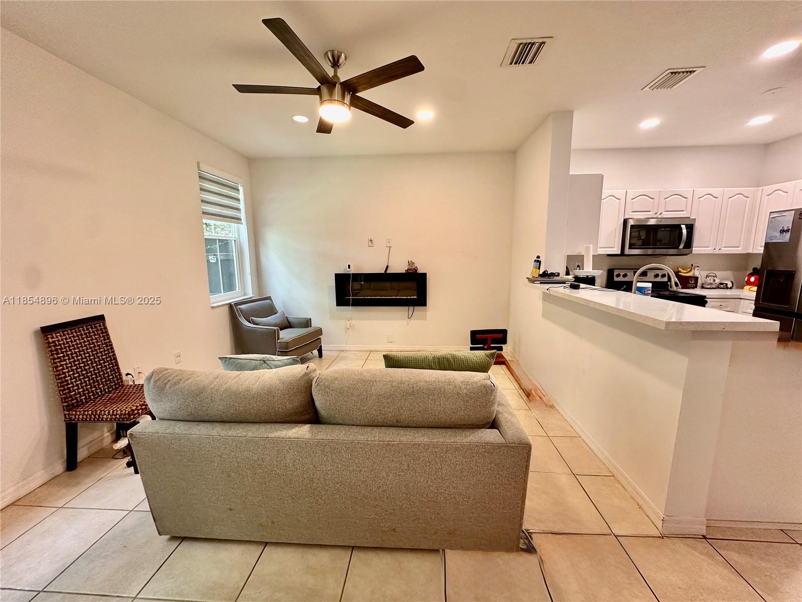 8908 Southwest 109th Avenue Miami, FL 33176 - Photo 7 of 28 a living room with furniture and a flat screen tv