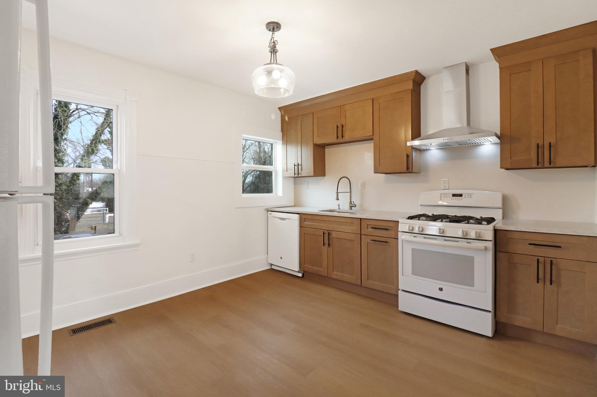 24369 West Main Street, Unit A Columbus, NJ 08022 - Photo 20 of 69 a kitchen with stainless steel appliances a stove a sink and white cabinets