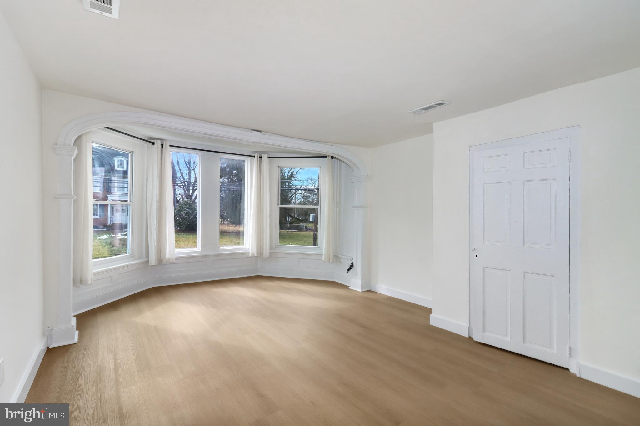 24369 West Main Street, Unit A Columbus, NJ 08022 - Photo 33 of 69 a view of an empty room with a window and wooden floor