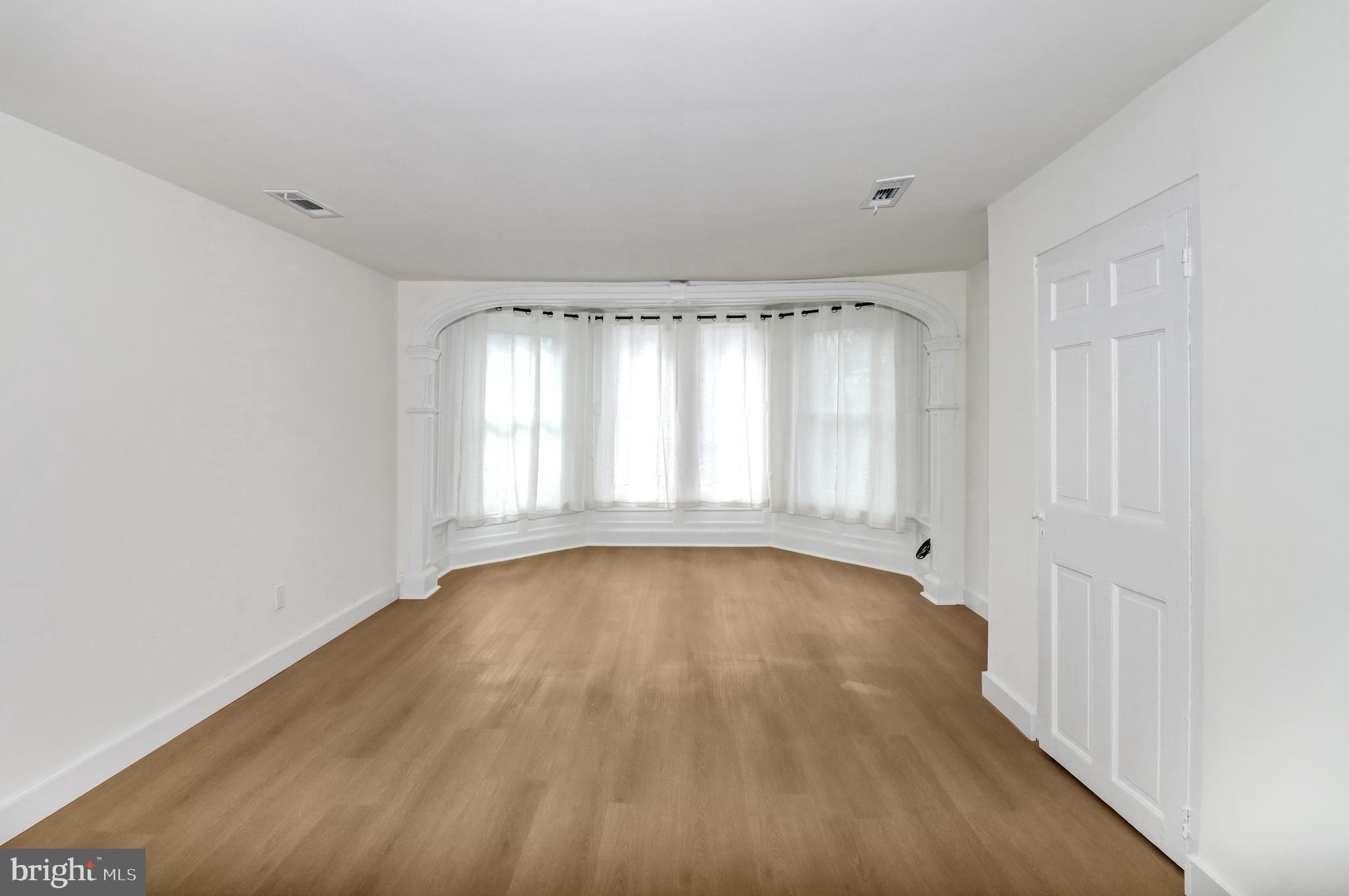 24369 West Main Street, Unit A Columbus, NJ 08022 - Photo 40 of 69 a view of an empty room with wooden floor and a window