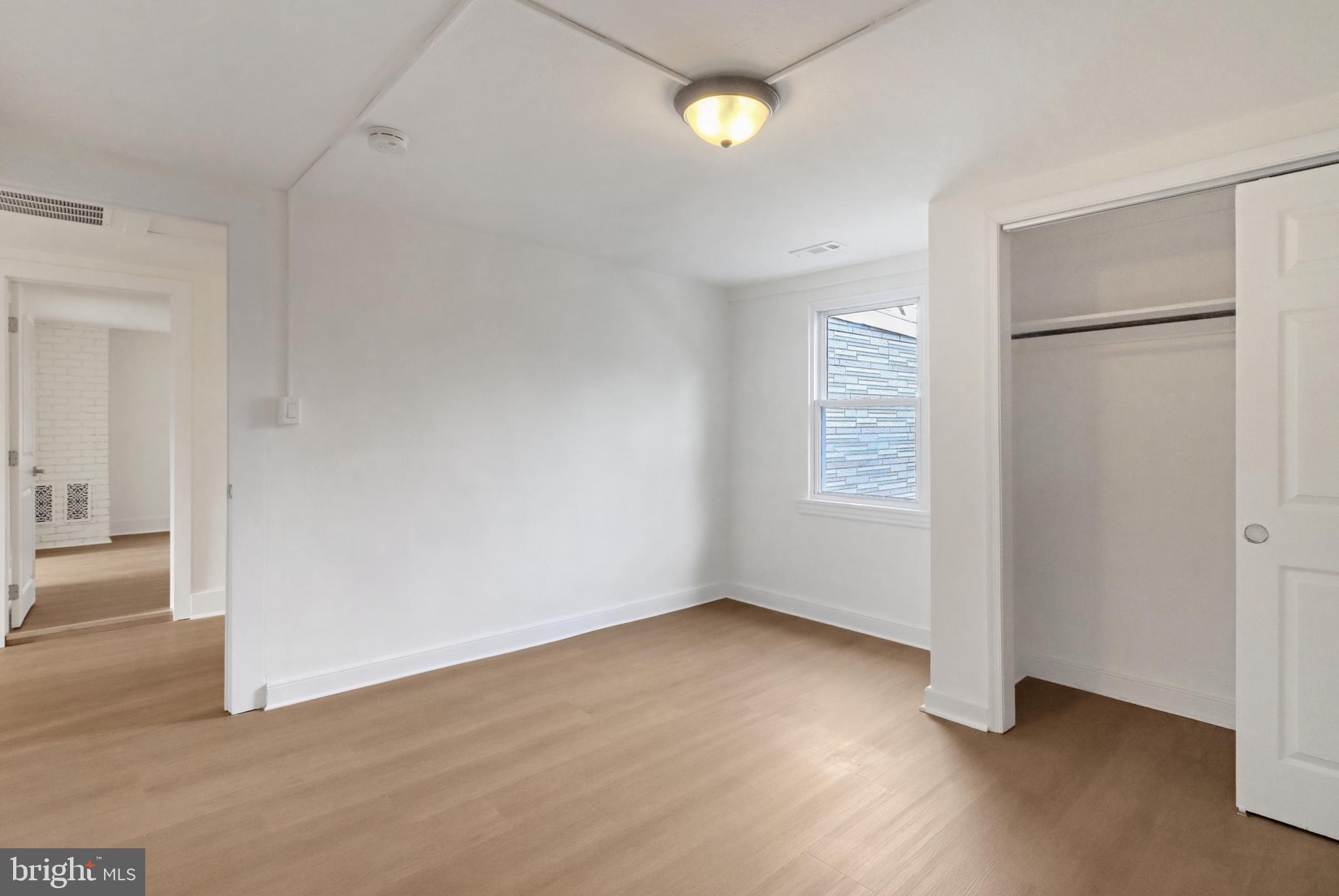 24369 West Main Street, Unit A Columbus, NJ 08022 - Photo 48 of 69 an empty room with wooden floor and windows