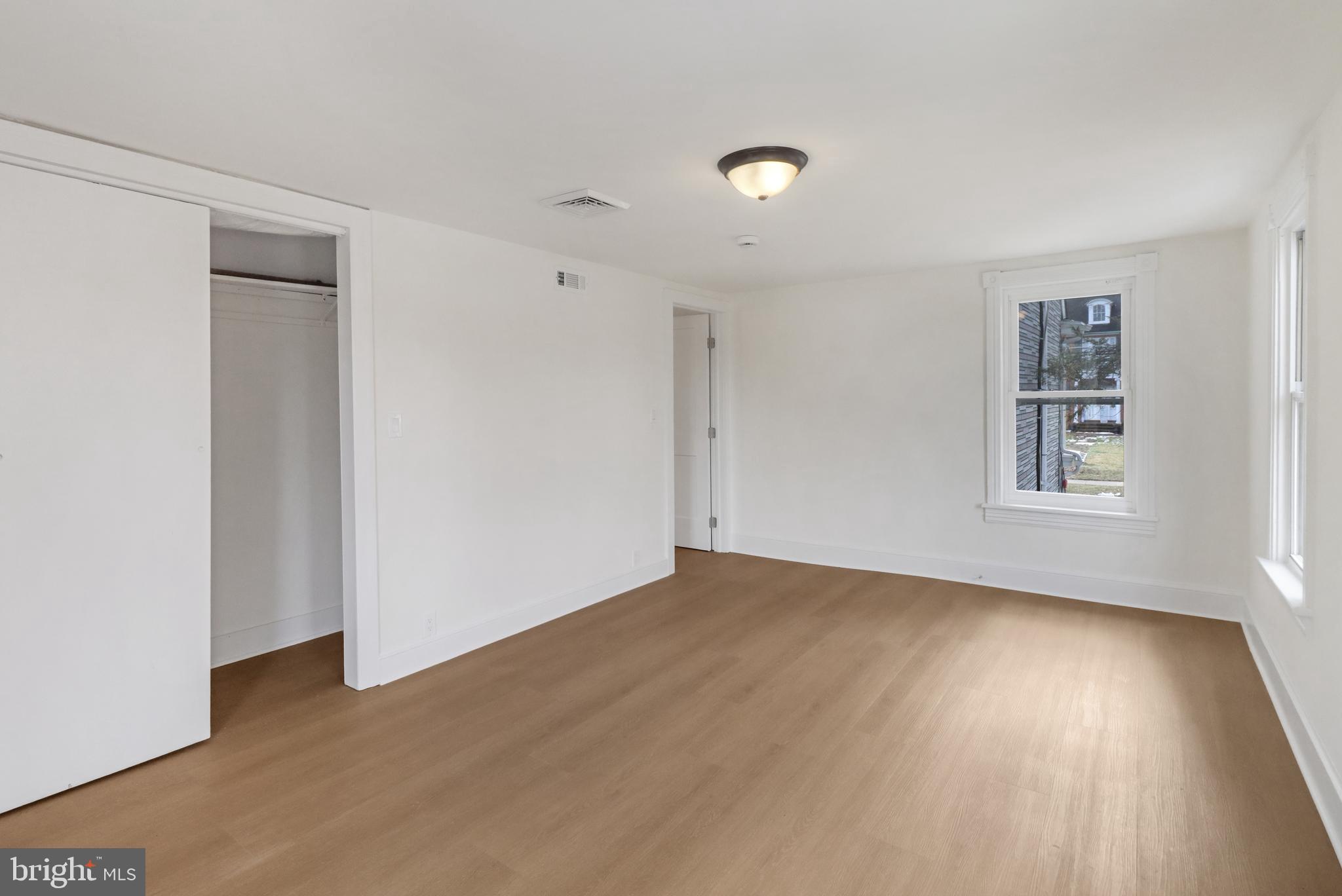 24369 West Main Street, Unit A Columbus, NJ 08022 - Photo 52 of 69 a view of an empty room with wooden floor and a window