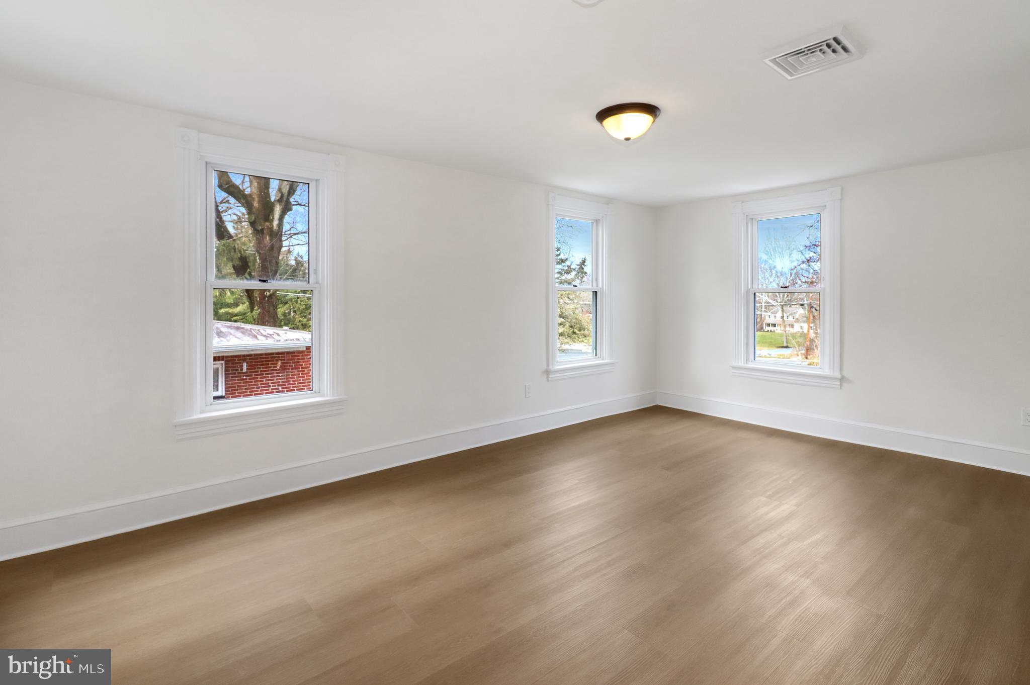 24369 West Main Street, Unit A Columbus, NJ 08022 - Photo 55 of 69 a view of an empty room with a window and wooden floor
