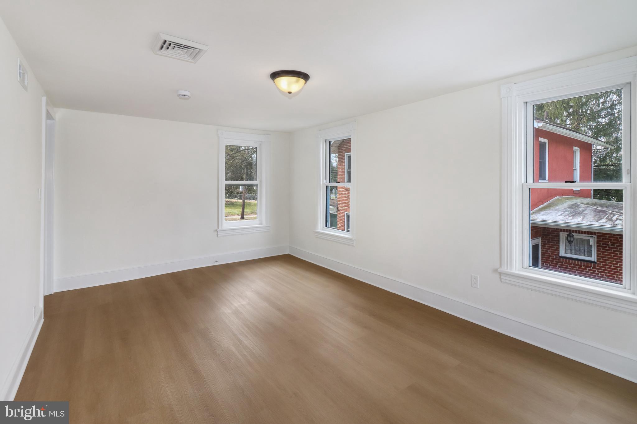 24369 West Main Street, Unit A Columbus, NJ 08022 - Photo 56 of 69 a view of an empty room with window and wooden floor