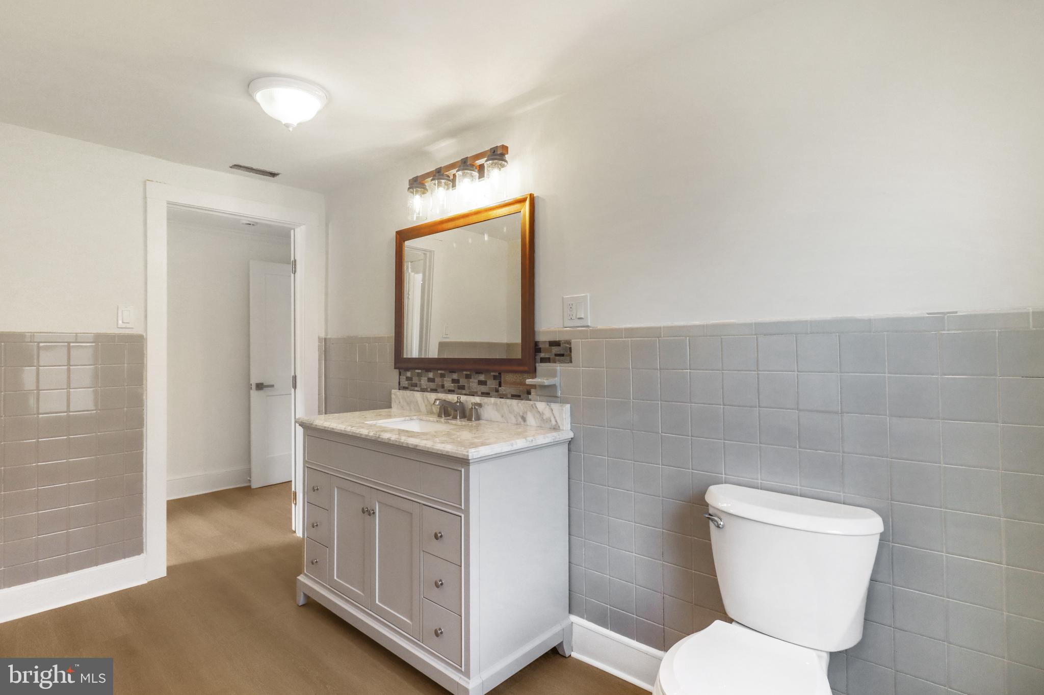 24369 West Main Street, Unit A Columbus, NJ 08022 - Photo 57 of 69 a bathroom with a toilet a sink and mirror