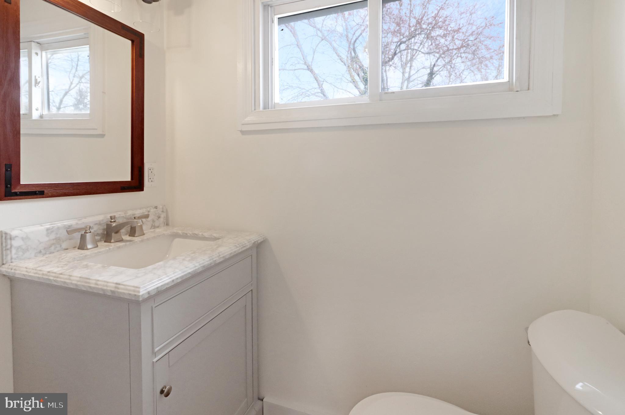 24369 West Main Street, Unit A Columbus, NJ 08022 - Photo 61 of 69 a bathroom with a granite countertop toilet sink and mirror