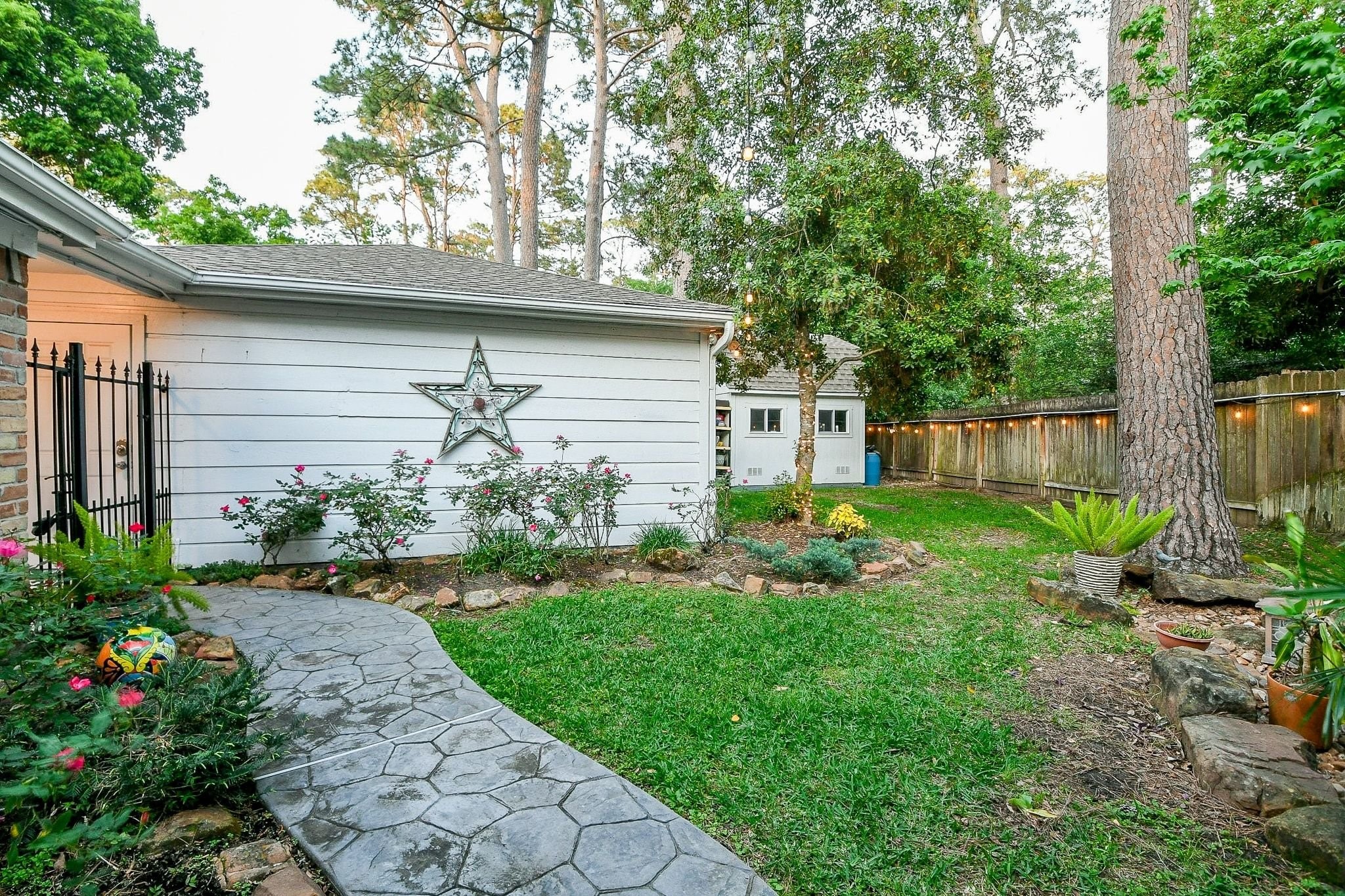 6607 Misty Springs Lane Spring, TX 77379 - Photo 29 of 31 Here's a view of the spacious two-car garage and convenient storage building nestled in a lush backyard setting.