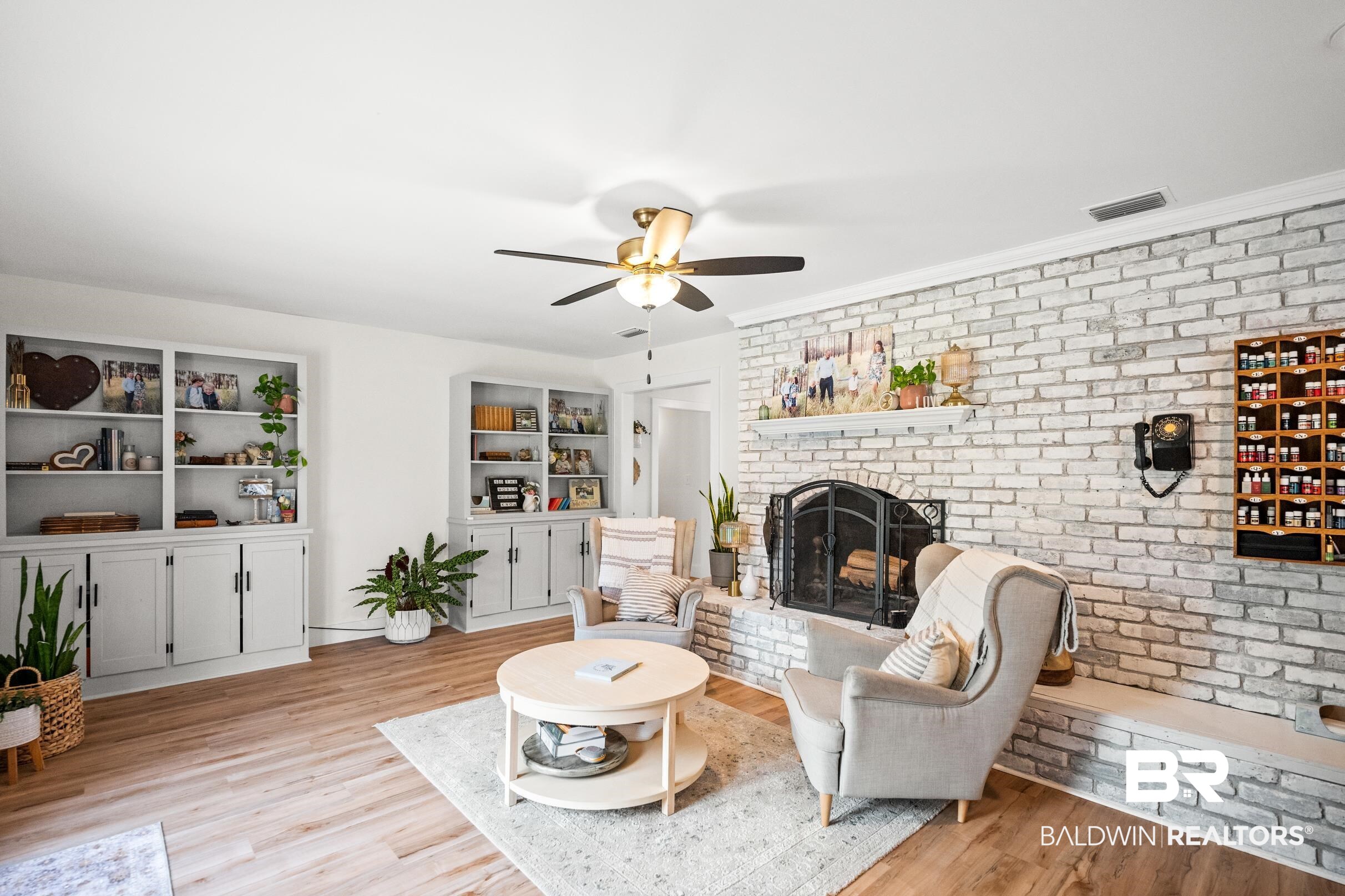 6 Wren Circle Foley, AL 36535 - Photo 35 of 55 Living room featuring visible vents, brick wall, a fireplace, and light wood finished floors