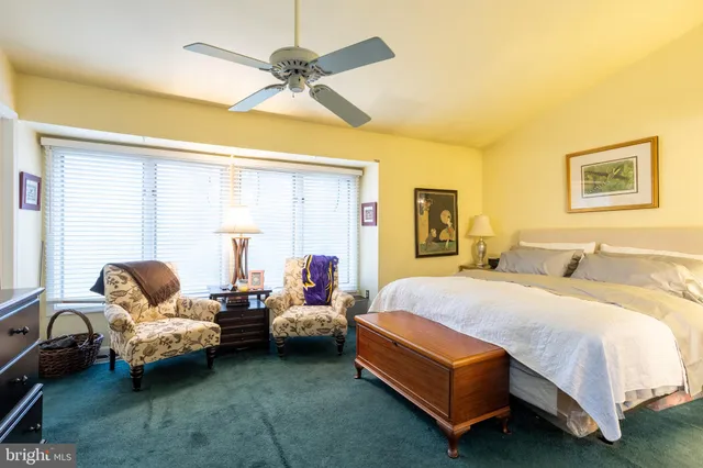 a bedroom with a bed couch and window