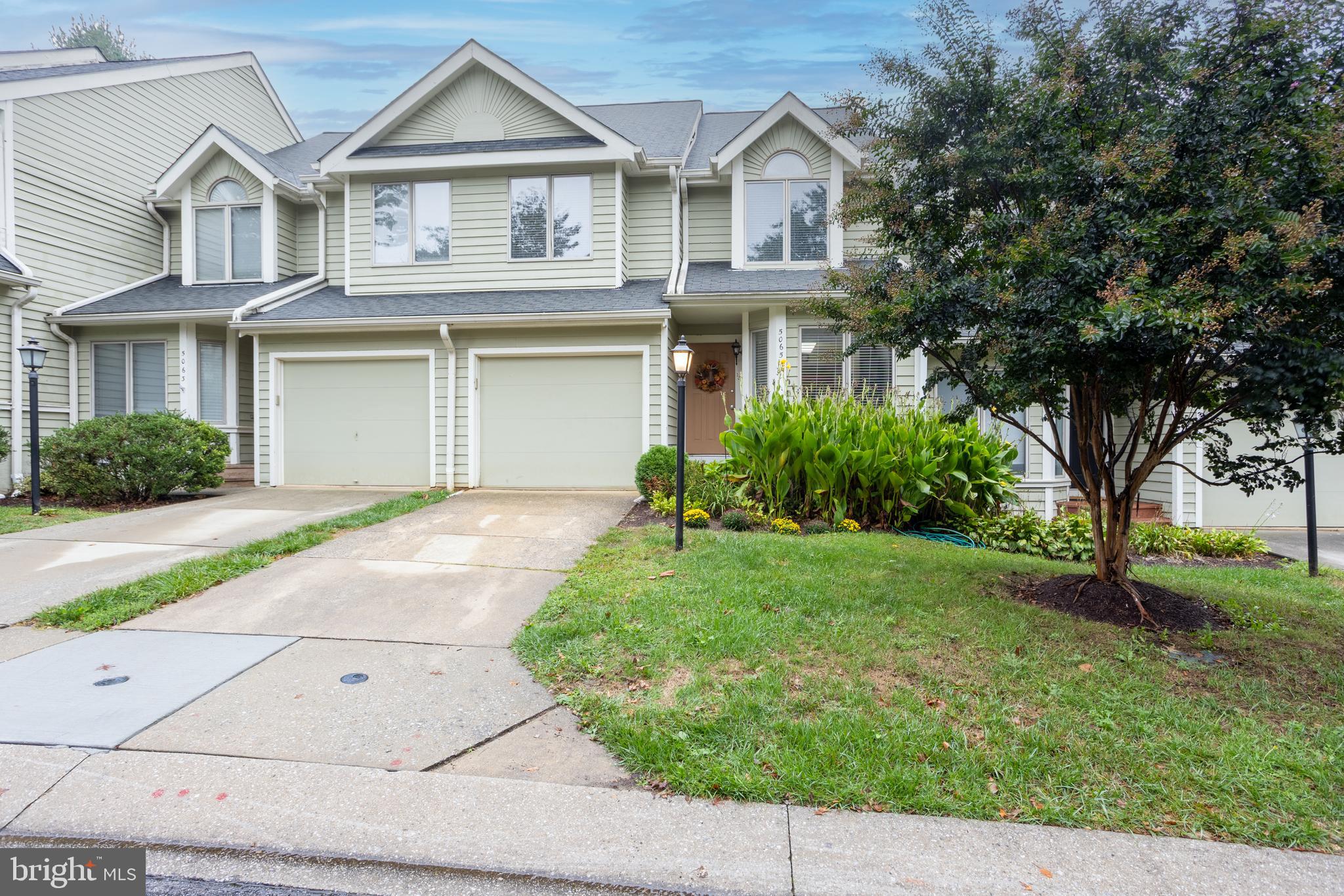 5065 Columbia Road, Unit 18 11 Columbia, MD 21044 - Photo 2 of 51 a front view of a house with a yard and garage