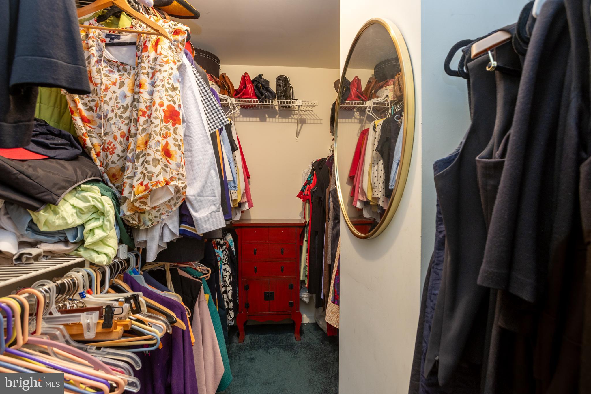 5065 Columbia Road, Unit 18 11 Columbia, MD 21044 - Photo 22 of 51 a view of walk in closet with clothes and shoes