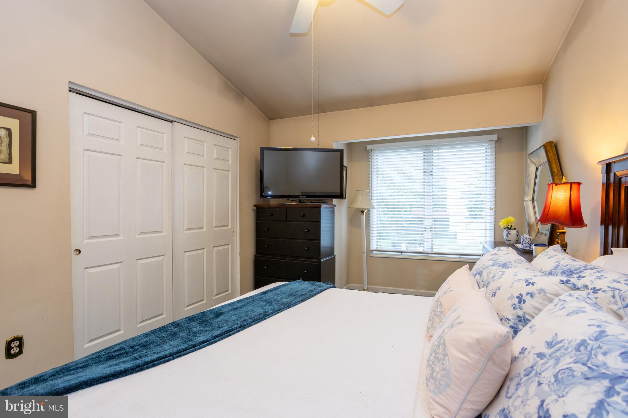 5065 Columbia Road, Unit 18 11 Columbia, MD 21044 - Photo 26 of 51 a bedroom with a bed and a fireplace