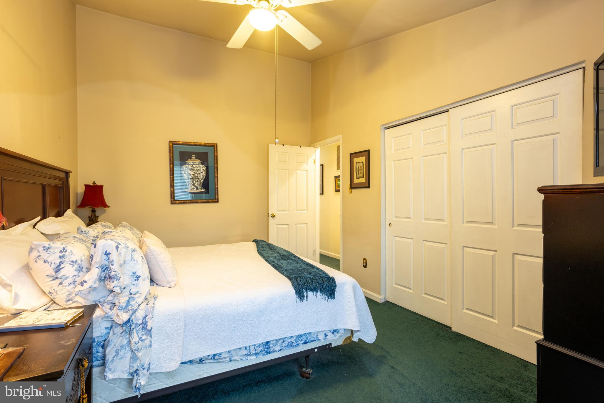 5065 Columbia Road, Unit 18 11 Columbia, MD 21044 - Photo 27 of 51 a bedroom with a bed and a chandelier