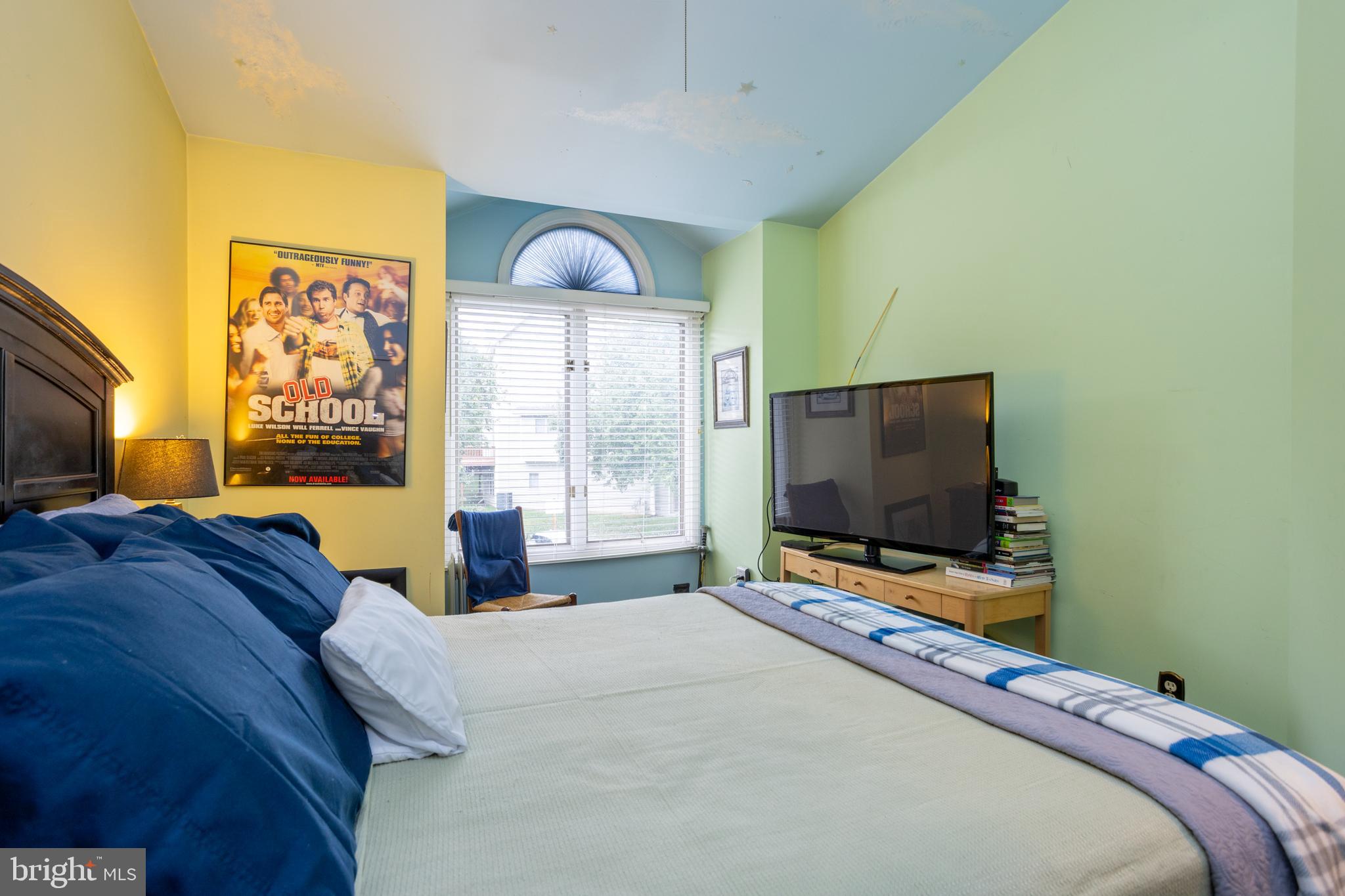 5065 Columbia Road, Unit 18 11 Columbia, MD 21044 - Photo 29 of 51 a bedroom with a bed and a flat screen tv