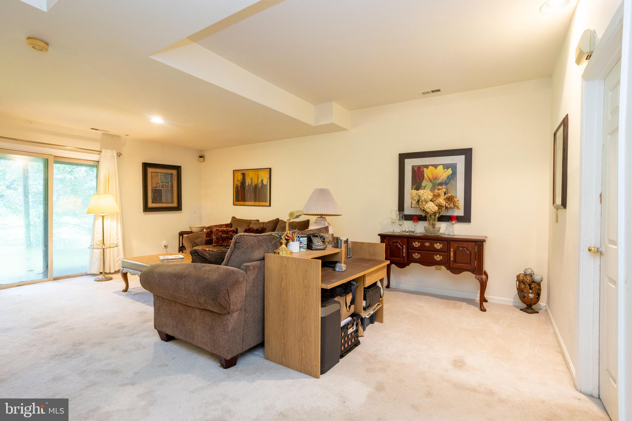 5065 Columbia Road, Unit 18 11 Columbia, MD 21044 - Photo 34 of 51 a living room with furniture and a flat screen tv