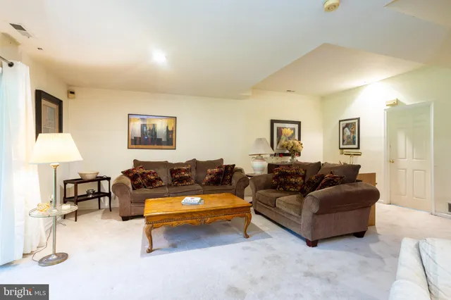 a living room with furniture and a lamp