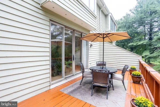 a view of a patio with a table and chairs under an umbrella