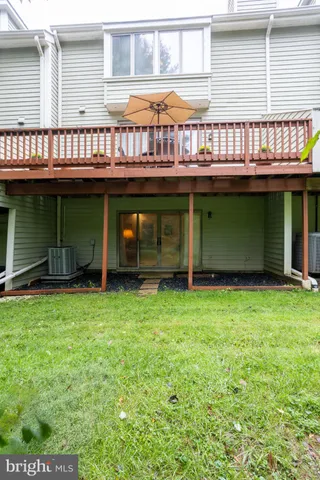 a view of a backyard with a small cabin and wooden fence