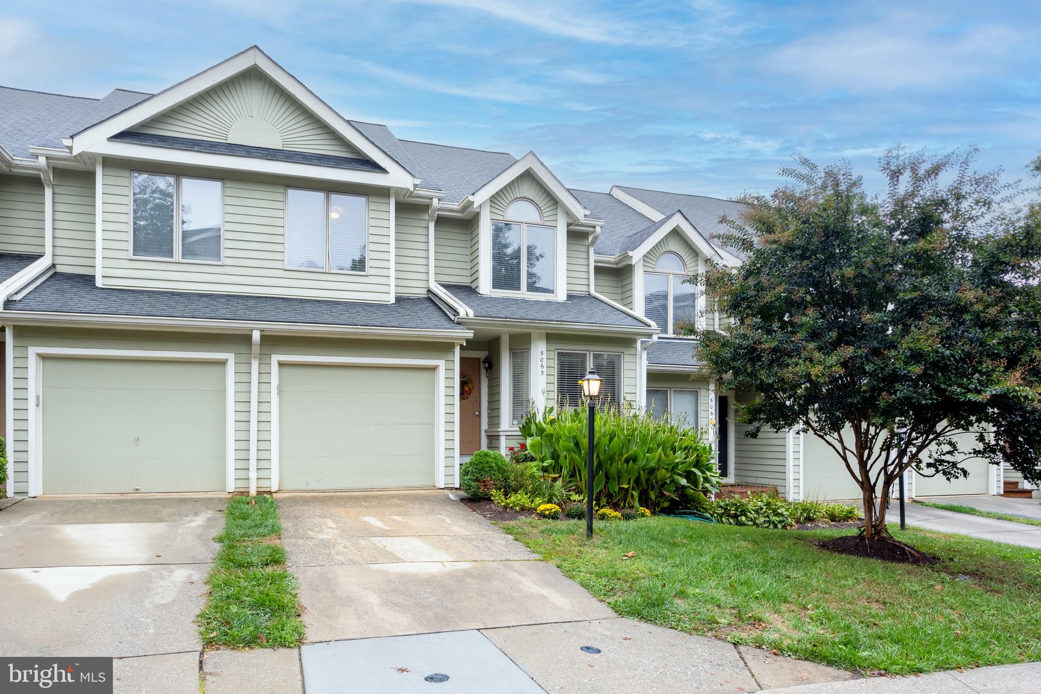 5065 Columbia Road, Unit 18 11 Columbia, MD 21044 - Photo 50 of 51 a front view of a house with a yard and garage