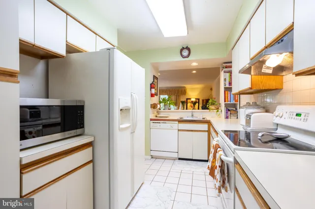 a kitchen with a sink cabinets and stainless steel appliances