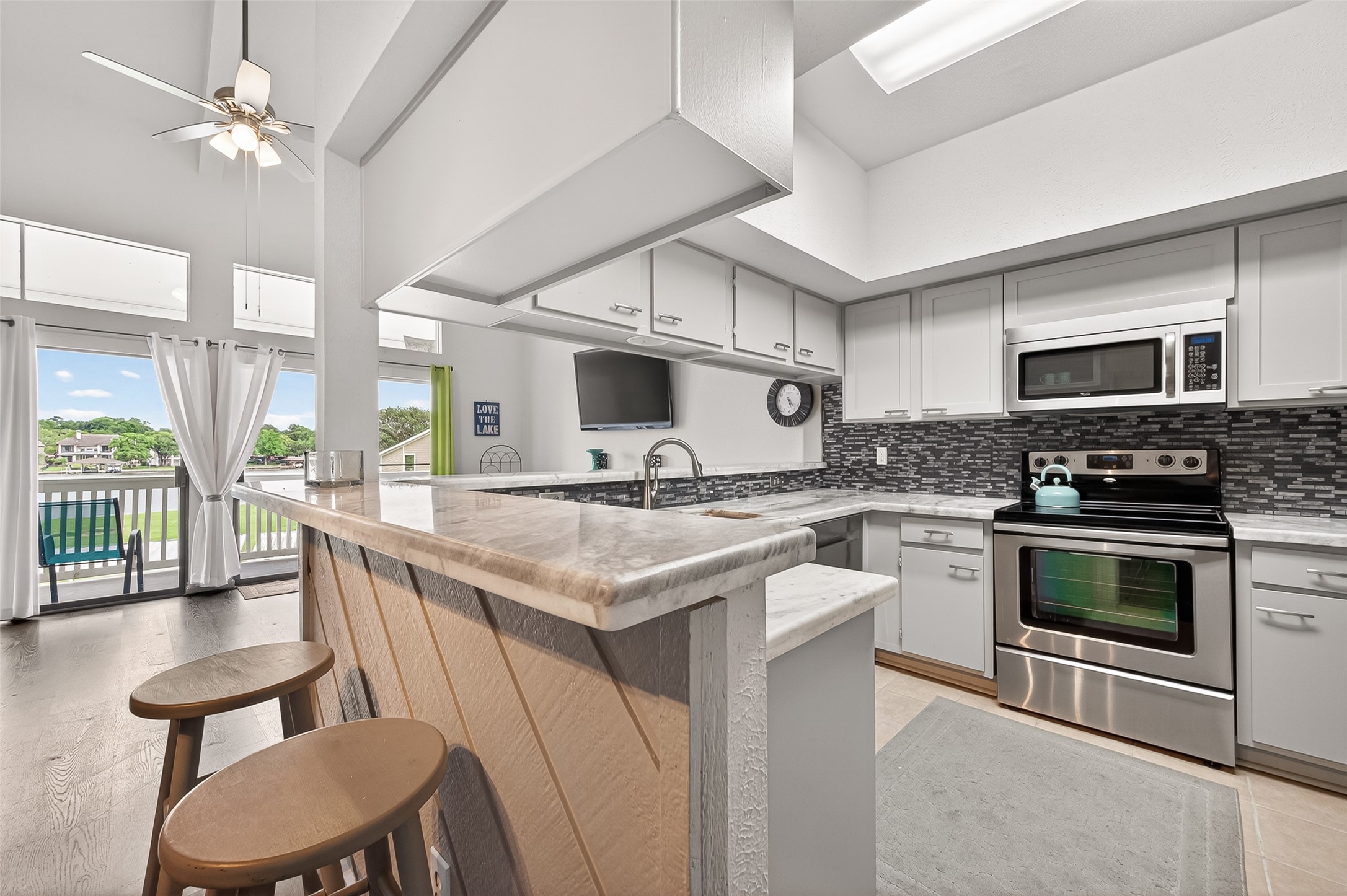 168 April Point Drive South, Unit 168 Conroe, TX 77356 - Photo 15 of 39 a kitchen with stainless steel appliances granite countertop a stove and a sink