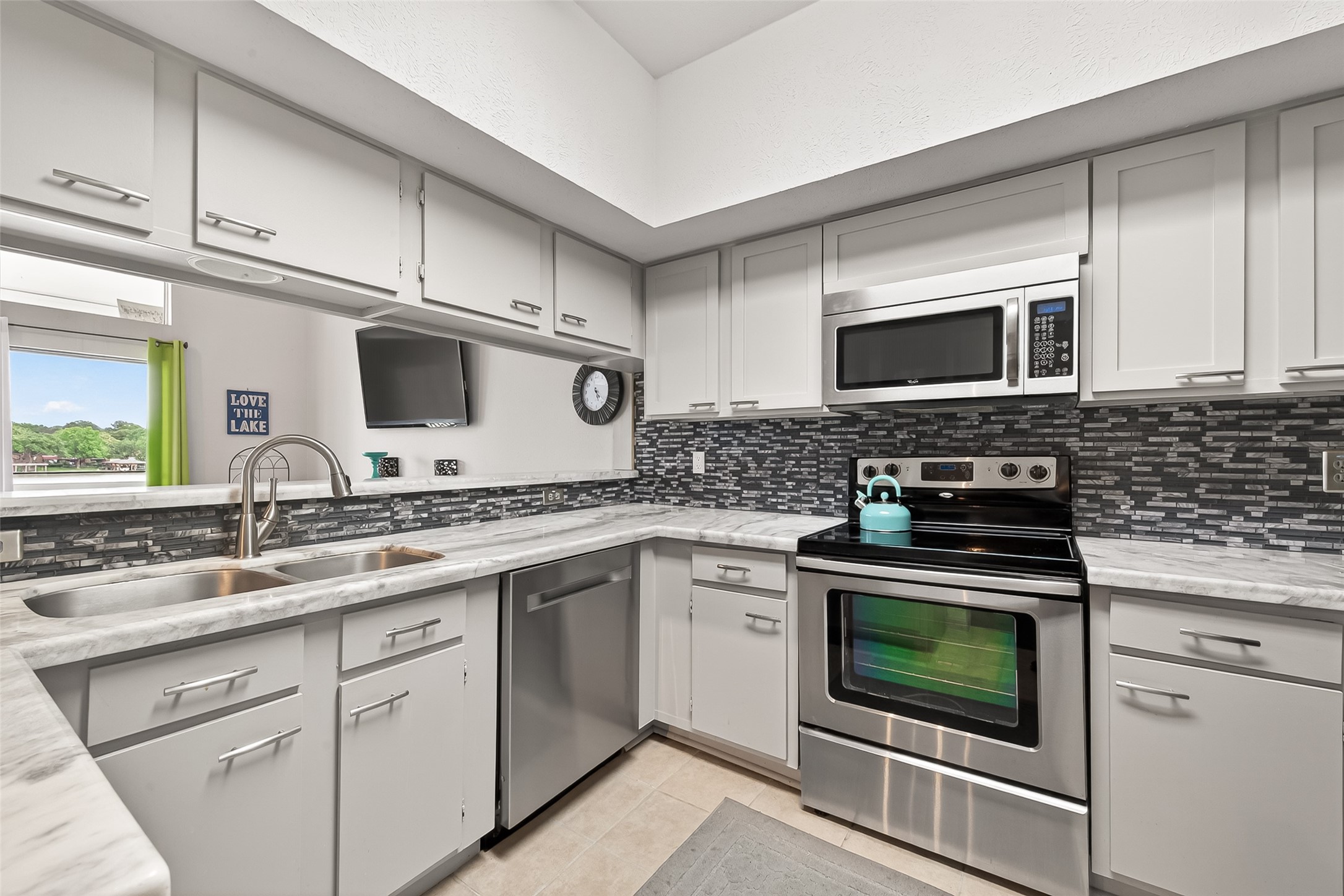 168 April Point Drive South, Unit 168 Conroe, TX 77356 - Photo 16 of 39 a kitchen with cabinets stainless steel appliances and a sink