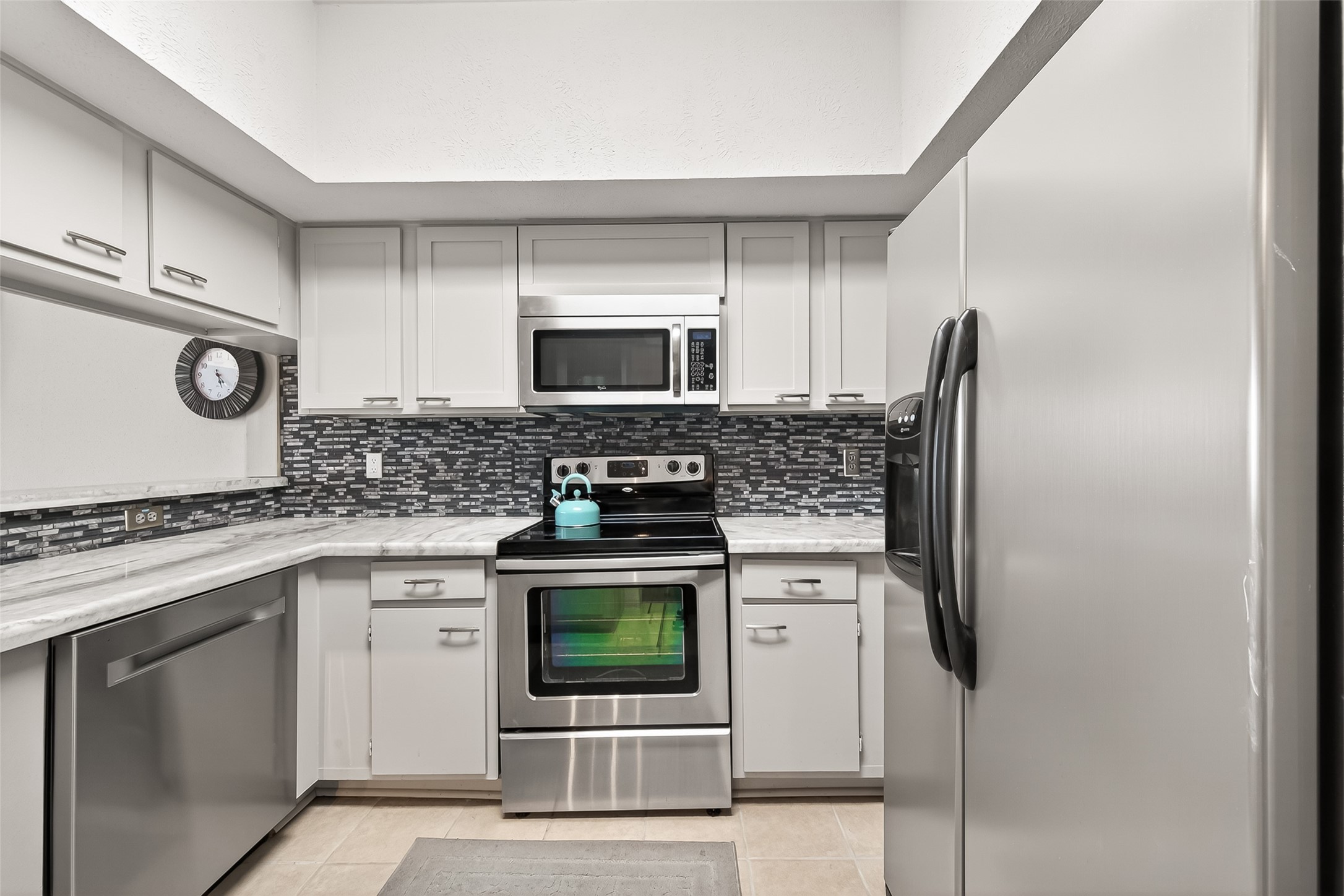 168 April Point Drive South, Unit 168 Conroe, TX 77356 - Photo 17 of 39 a kitchen with stainless steel appliances granite countertop a stove and a microwave