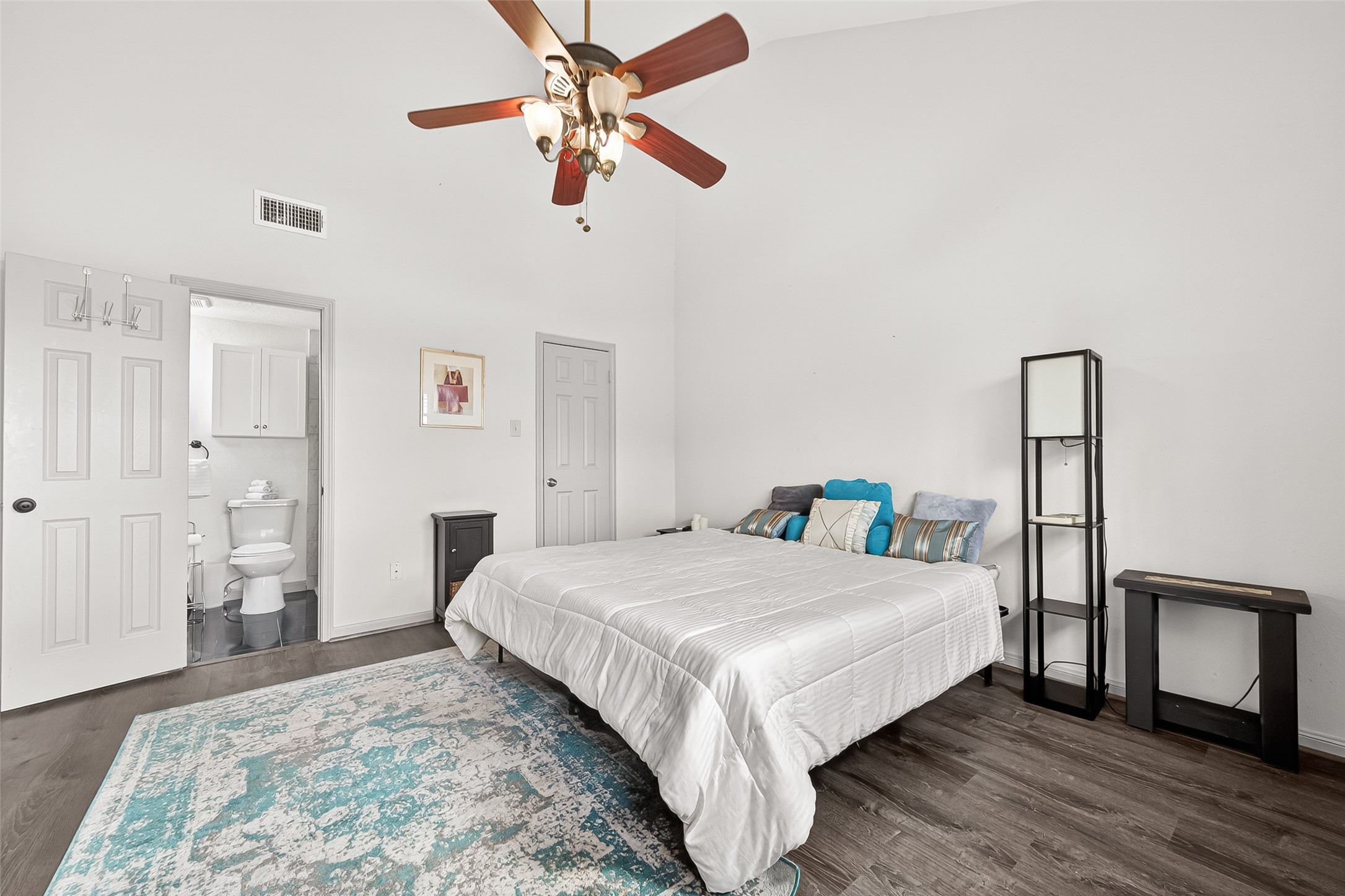 168 April Point Drive South, Unit 168 Conroe, TX 77356 - Photo 20 of 39 a bedroom with a bed and a chandelier