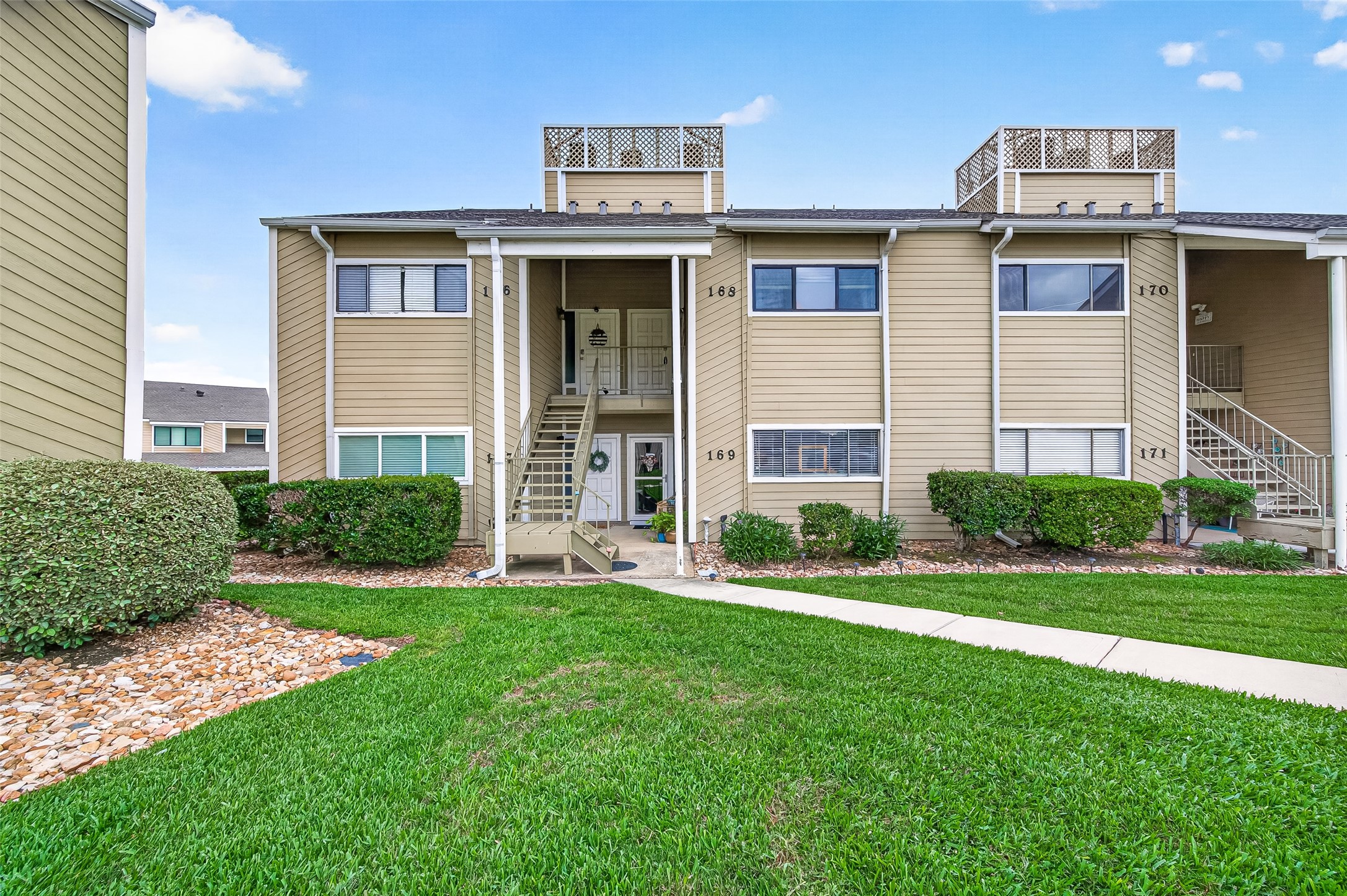 168 April Point Drive South, Unit 168 Conroe, TX 77356 - Photo 2 of 39 front view of a house with a yard