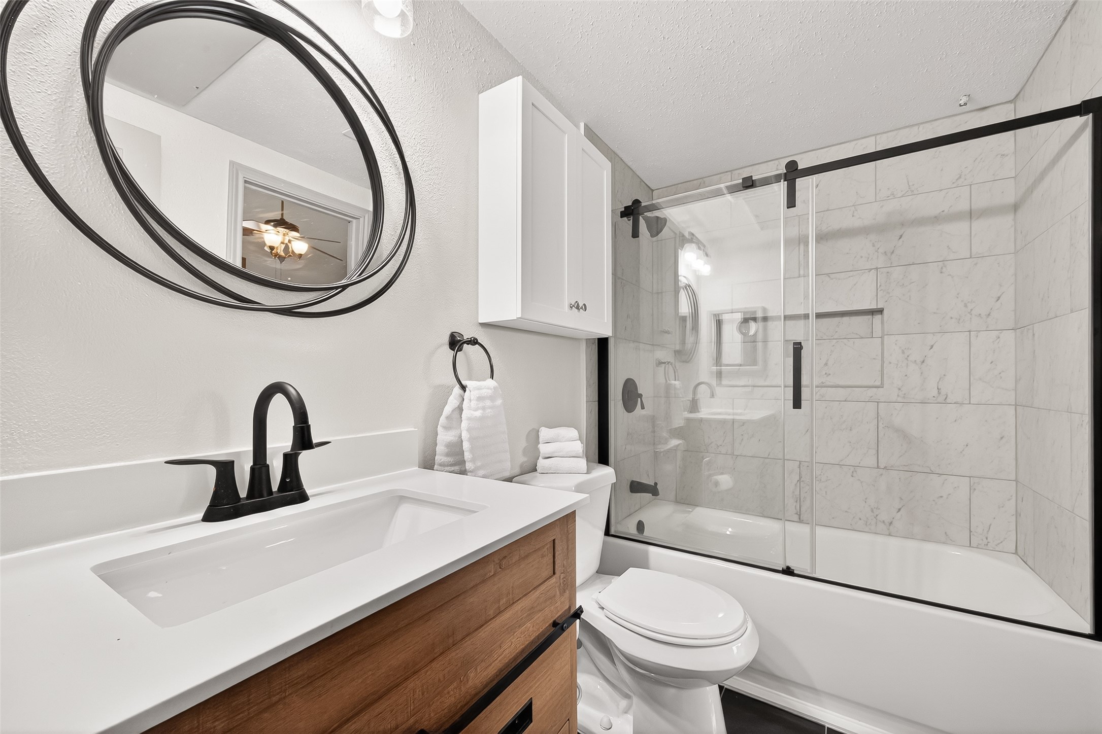 168 April Point Drive South, Unit 168 Conroe, TX 77356 - Photo 21 of 39 a bathroom with a sink a toilet and a mirror